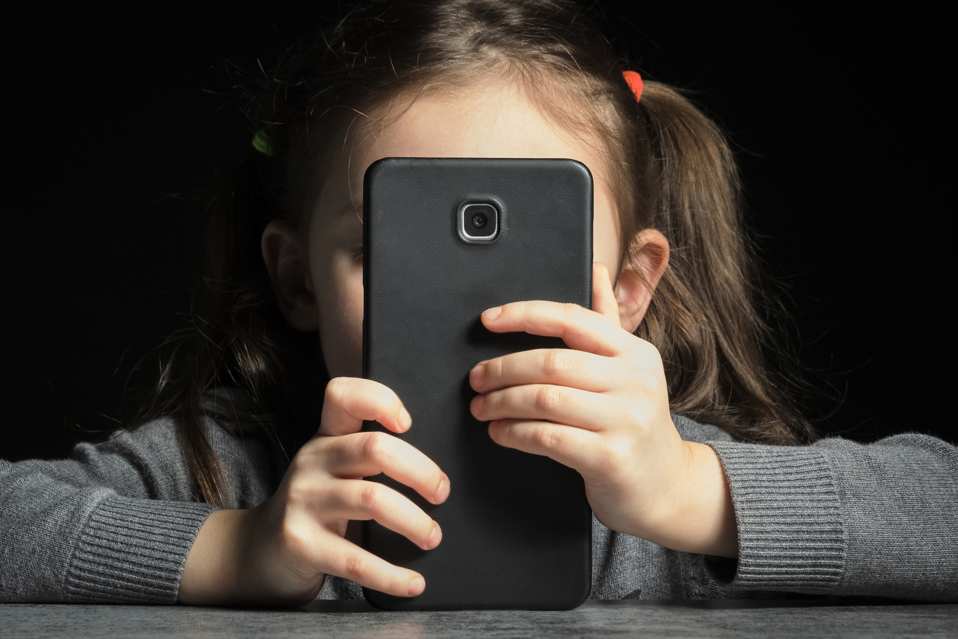 PHOTO: A child looks a phone screen in this undated stock photo. 