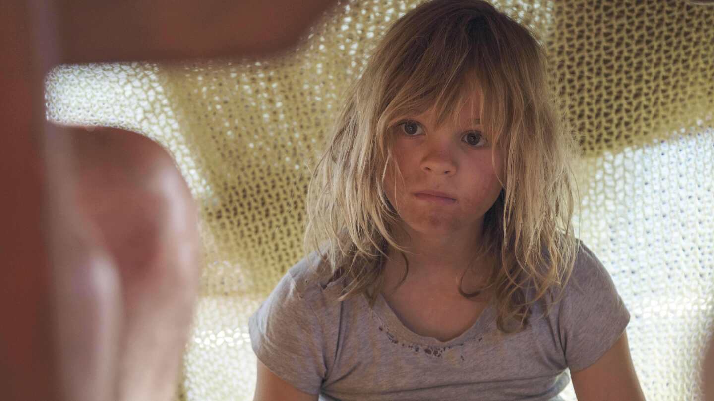 Movie Review: War, through one child’s extraordinary eyes, in ‘Don’t Let’s Go to the Dogs Tonight’